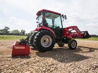 Man smoothing out dirt with a 2019 Mahindra 1640 HST Cab